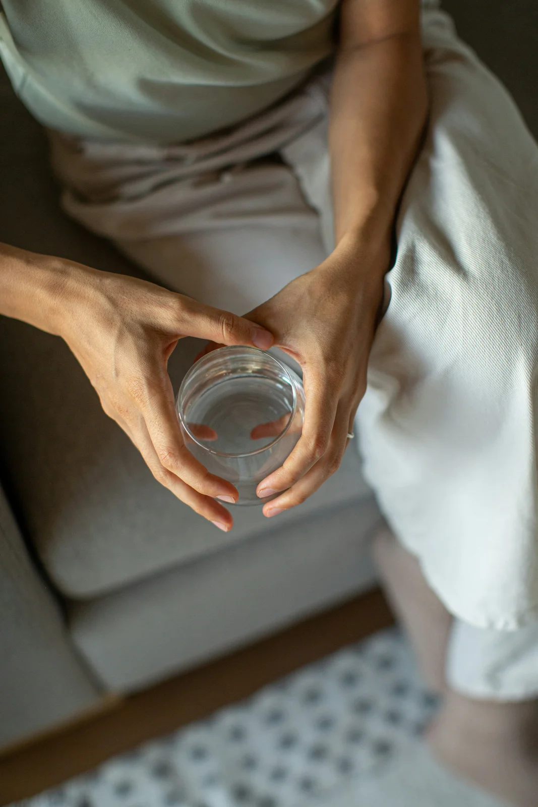 Seated man holding a glass of water